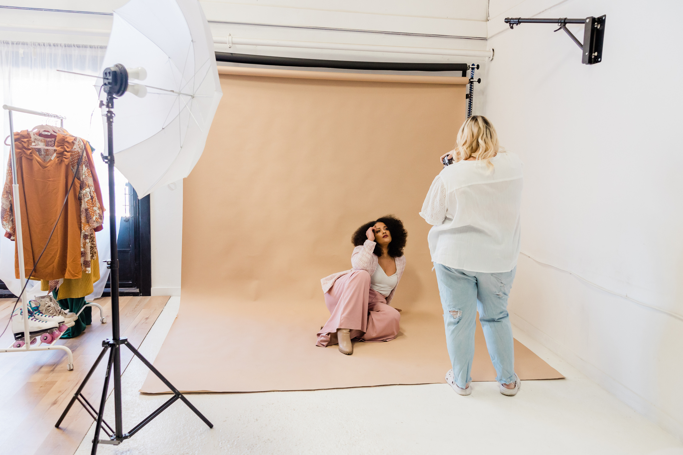 Female Photographer Taking Photos of Model in Studio